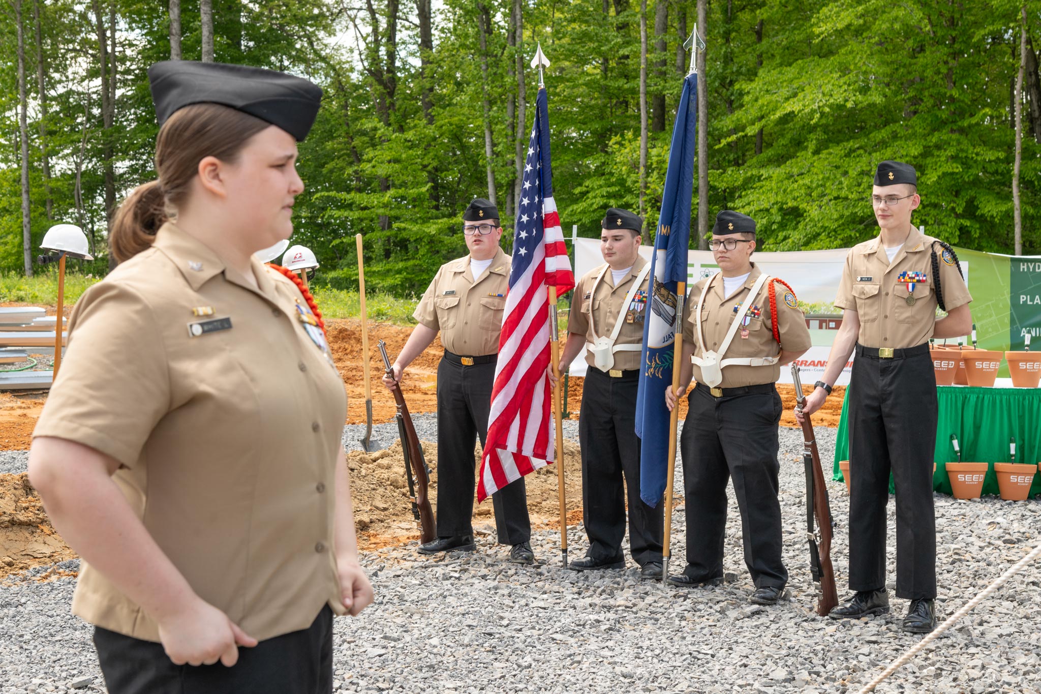 Student honor guards at attention holding flags