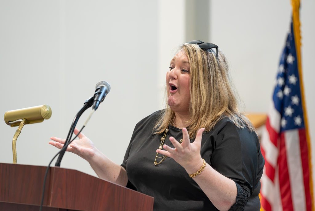 Woman addressing audience at podium