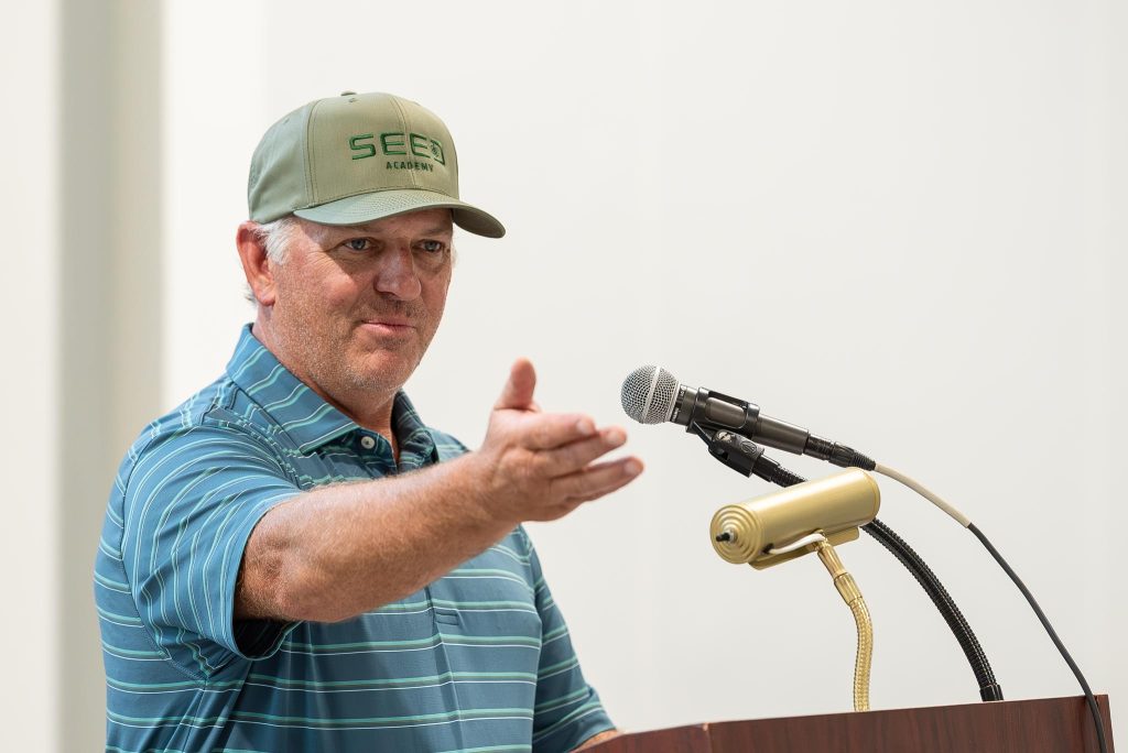 Man wearing SEED Academy cap at podium