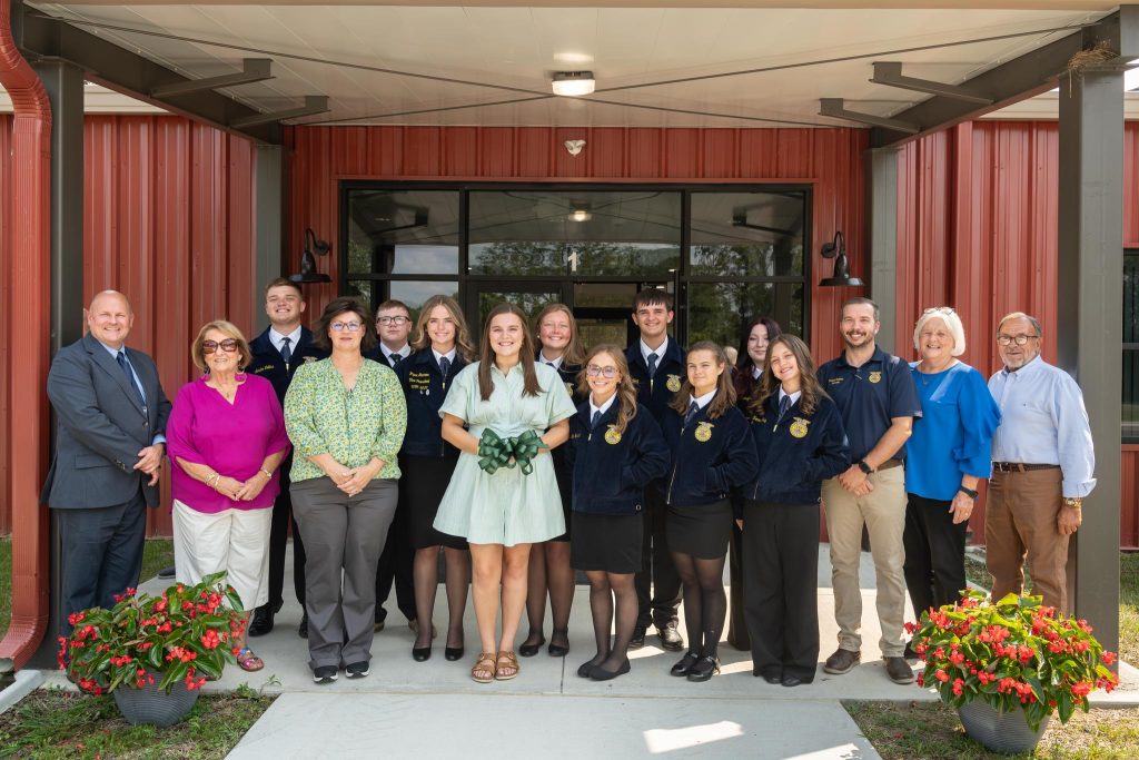 people in front of building for ribbon cutting