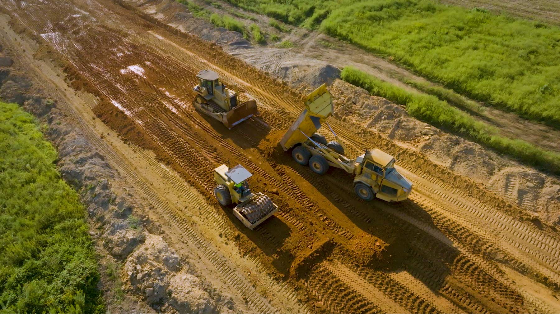 Large earth moving machines on road construction site