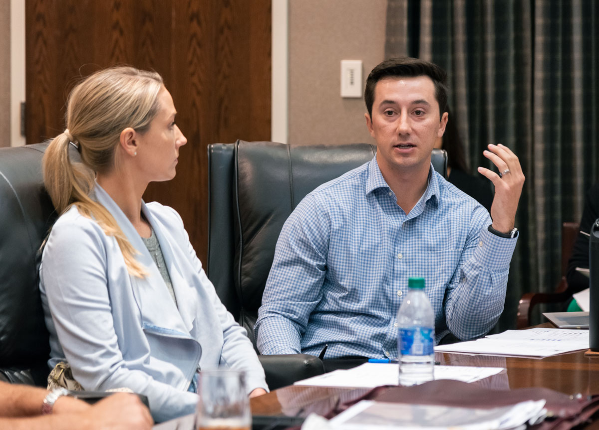 two people talking during a board meeting