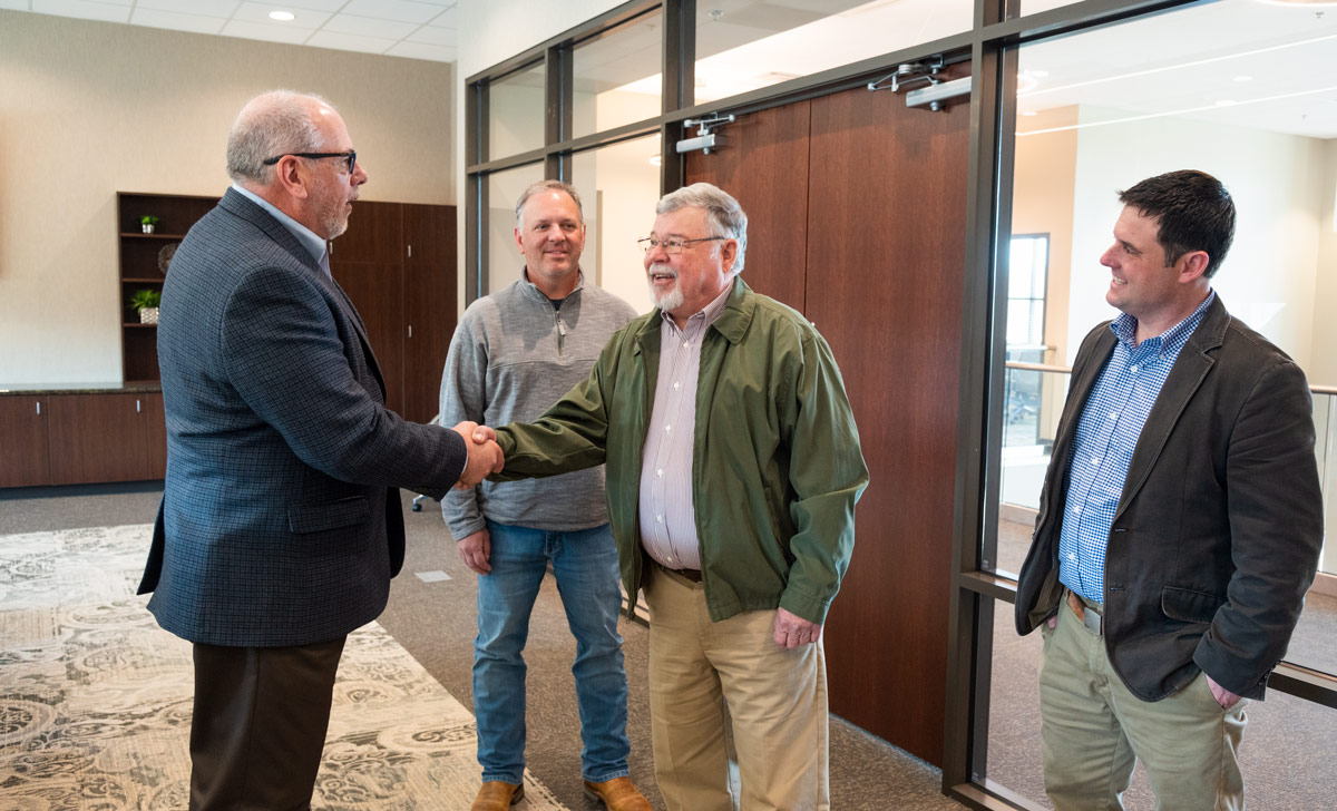 smiling men shaking hands