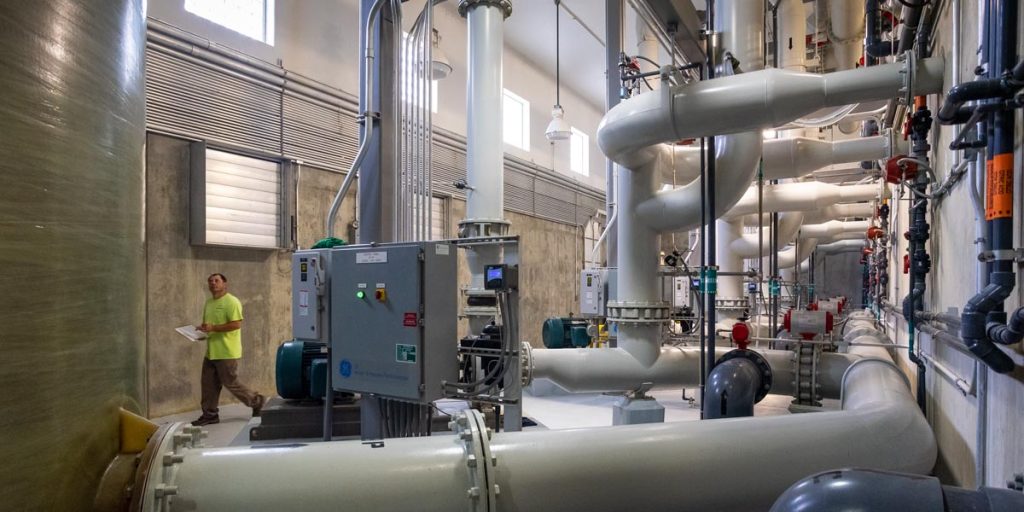 Water plant employee walking though treatment facility
